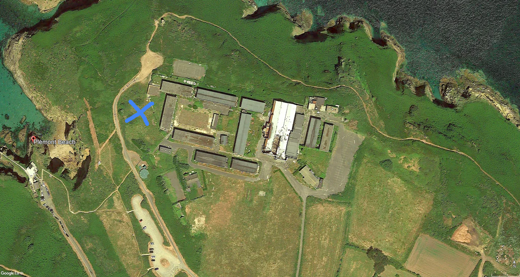 Aerial view of Pontins Plemont Bay after closure. The blue cross marks the former location of the Plemont Hotel