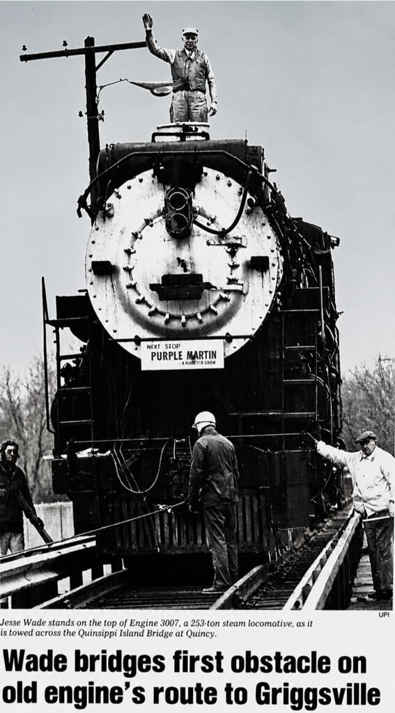 Hudson steam loco No. 3007 being winched across the bridge at Quinsippi Island in 1980 with new owner Jesse Wade standing on top